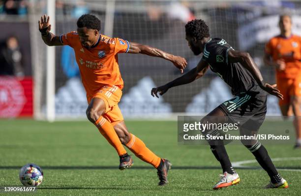 Alvas Powell is tracked by Derrick Jones during a game between FC Cincinnati and Charlotte FC at Bank of America Stadium on March 26, 2022 in...