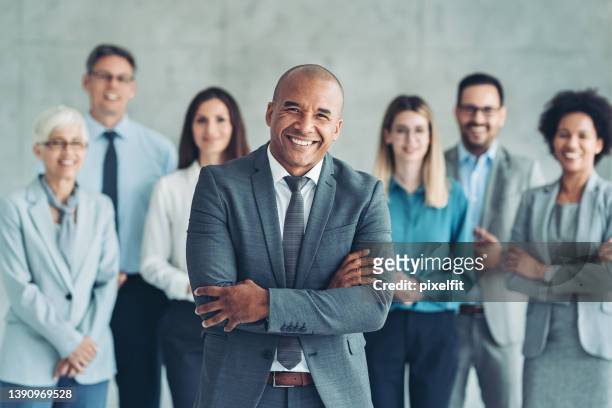 smiling businessman with his team - bussines group suit tie stock pictures, royalty-free photos & images