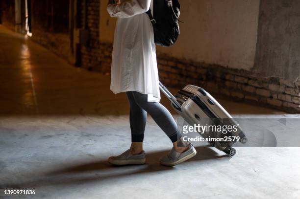 woman traveler tourist walking with luggage to start her journey - sleep walking stockfoto's en -beelden