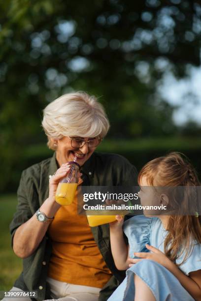 refreshment with granddaughter - woman playing squash stock pictures, royalty-free photos & images