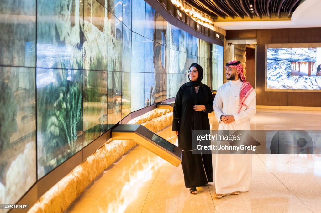 Couple admiring technology in At-Turaif visitor’s centre