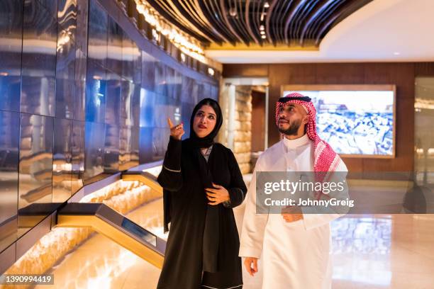 middle eastern tourists admiring museum’s technology display - saudi arabia people stock pictures, royalty-free photos & images