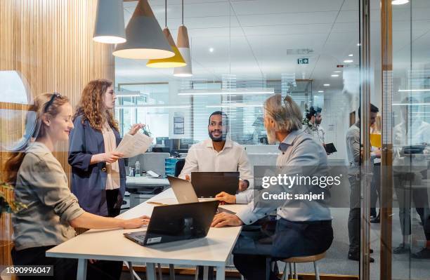 business people having a meeting - associate producer stock pictures, royalty-free photos & images