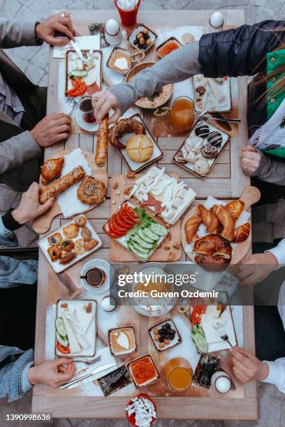 people eating breakfast, people eating, turkish breakfast,  sunday big breakfast or brunch with white cheese and egg, turkish spread breakfast served in the restaurant, menemen, orange juices - turkish stock pictures, royalty-free photos & images