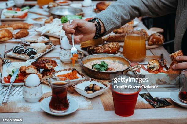 turkish breakfast, sunday big breakfast or brunch with feta cheese and eggs, turkish breakfast served in restaurant, man and woman having breakfast, man and woman eating, menemen for breakfast - turkish culture stock pictures, royalty-free photos & images