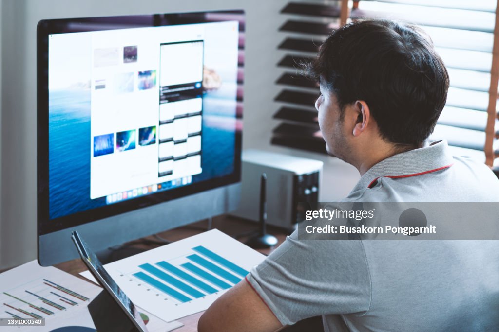 Man Using Computer Office Man Using Computer At Desk In Home Office High-Res Stock Photo - Getty ...