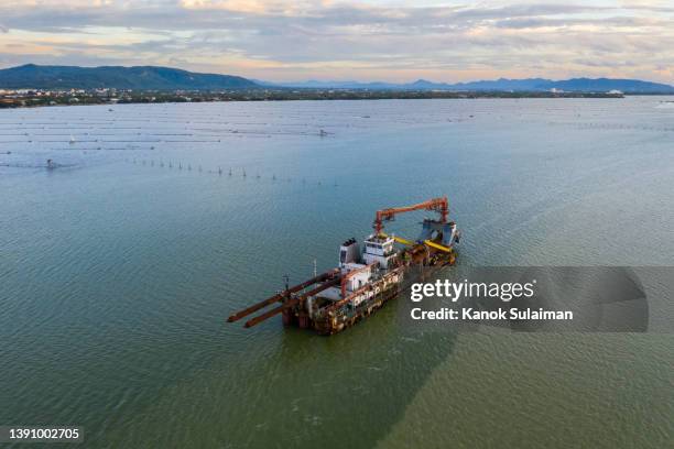 sand dredger at dusk with dramatic sky view from aerial - dredger stock pictures, royalty-free photos & images