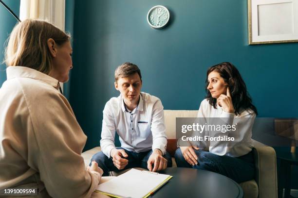 three persons talking in the office - family therapy stock-fotos und bilder