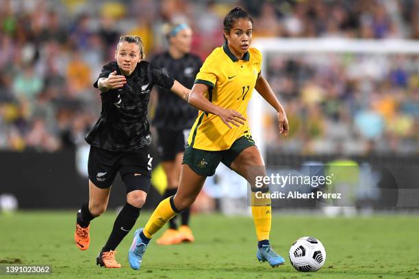 Mary Fowler of Australia dribbles the ball in front of Ria Percival of New Zealand during the International Women's match between the Australia...
