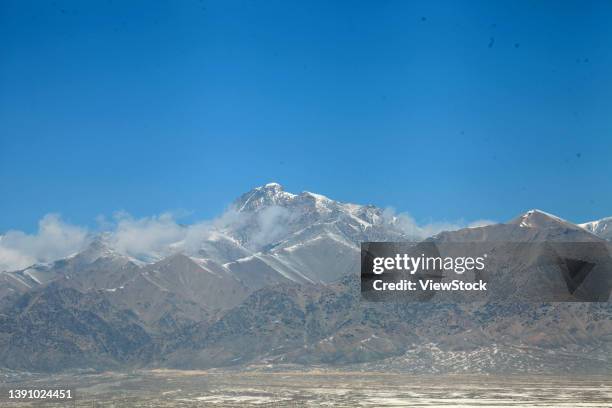 xinjiang hami snow back at the foot of tianshan mountain scenery - tien shan mountains stock pictures, royalty-free photos & images