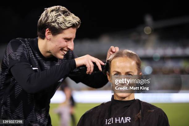 Aivi Luik of the Matildas has her head shaved by Rebekah Stott of New Zealand Ferns after the International womens friendly match between the...