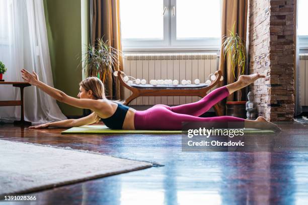 giovane donna pratica yoga a casa foto stock - prono foto e immagini stock