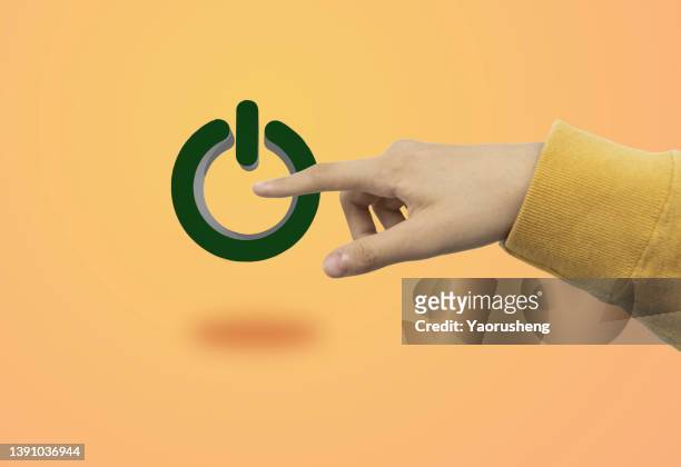 people hand pushing on the start button on green background - button concept stock pictures, royalty-free photos & images