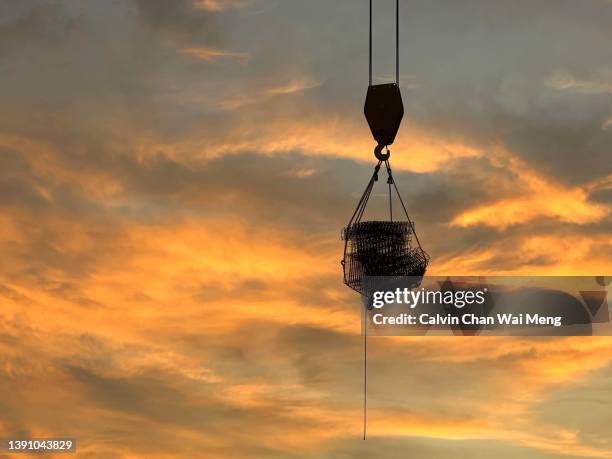 crane transporting building material - wire rope stock pictures, royalty-free photos & images