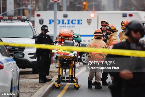 Police and emergency responders gather at the site of a reported shooting of multiple people outside of the 36 St subway station on April 12, 2022 in...