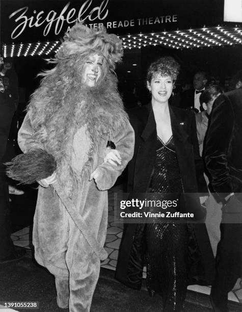 American actress and singer Bernadette Peters and an person in a Cowardly Lion costume attend the premiere of 'That's Dancing!, ' held at the...