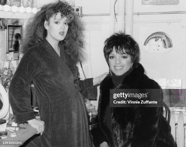 American actress and singer Bernadette Peters and American actress and singer Liza Minnelli backstage at an theatre, circa 1985. Peters is performing...