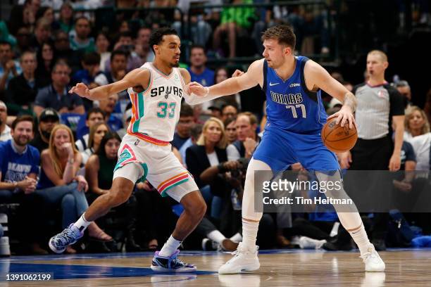 Luka Doncic of the Dallas Mavericks is guarded by Tre Jones of the San Antonio Spurs at American Airlines Center on April 10, 2022 in Dallas, Texas....