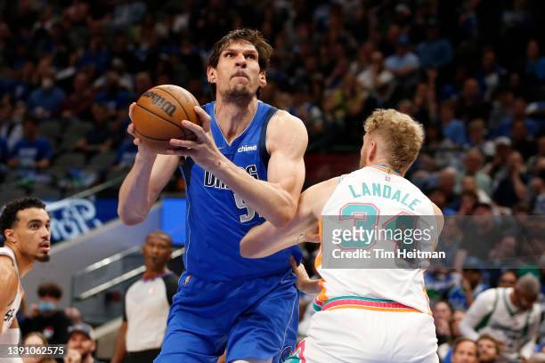 Boban Marjanovic of the Dallas Mavericks drives against Jock Landale of the San Antonio Spurs in the game at American Airlines Center on April 10,...
