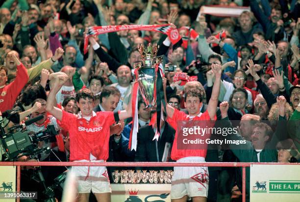 Manchester United captain Steve Bruce and Bryan Robson hold aloft the FA Premier League trophy after the final home game of the 1992/93 season,...