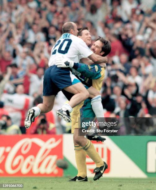 England Goalkeeper David Seaman is congratulated by players Steve Stone and Nick Barmby after the penalty shoot out after the UEFA Euro 96 quarter...