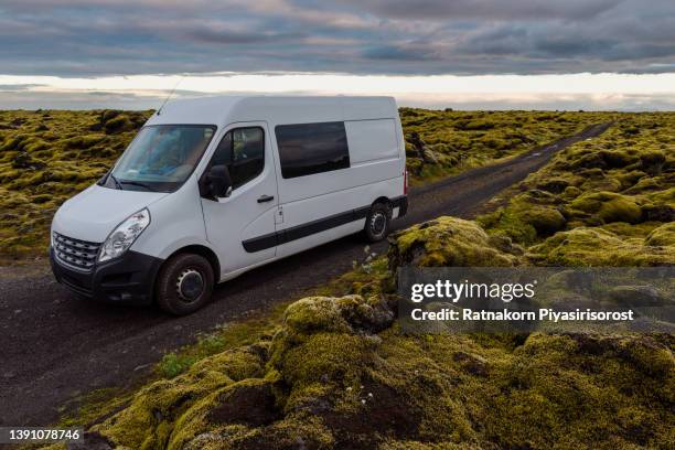 sunset scene of moss cover on volcanic landscape with motor home camping van car of iceland - minivan ストックフォトと画像