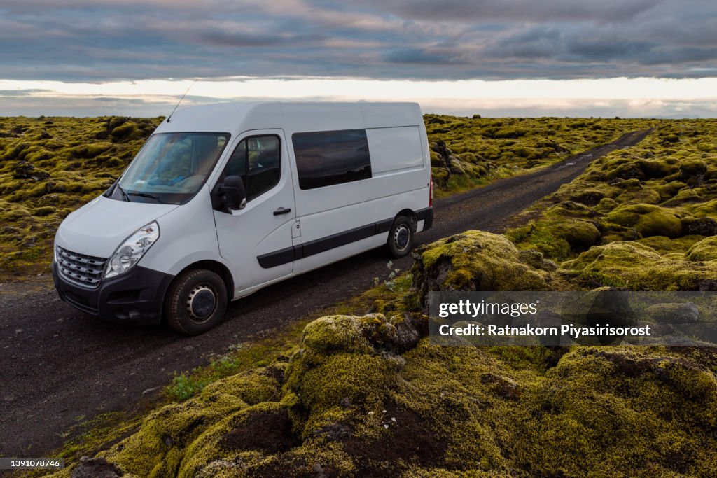 Sunset Scene of Moss cover on volcanic landscape with motor home camping van car of Iceland