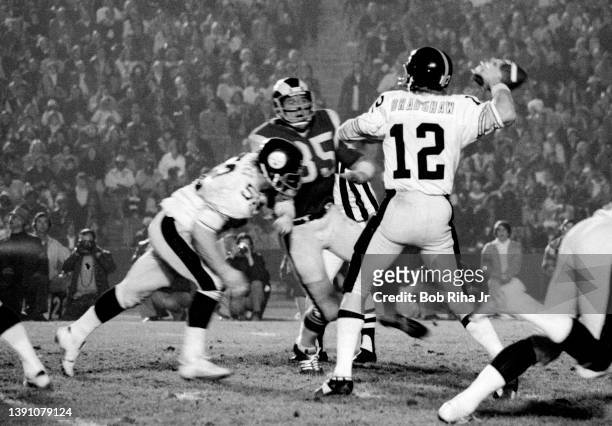 Pittsburgh Steelers QB Terry Bradshaw under pressure from Los Angeles Rams DE Jack Youngblood during game action of Los Angeles Rams against...