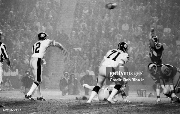 Pittsburgh Steelers Quarterback Terry Bradshaw under pressure from Los Angeles Rams Fred Dryer and Jack Youngblood during game action of Los Angeles...