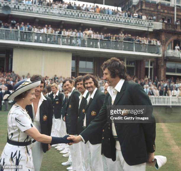 Queen Elizabeth II is introduced to Australian fast bowler Max Walker by captain Ian Chappell as Dennis Lillee and team mates look on at Lords during...