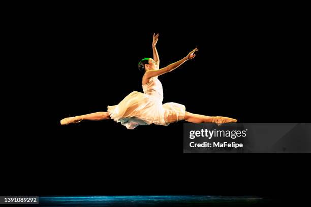 teenage girl dancing neoclassical ballet on stage - show jumping stock pictures, royalty-free photos & images