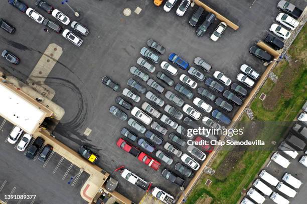 In an aerial view, a CarMax lot holds hundreds of used cars and trucks on April 12, 2022 in Gaithersburg, Maryland. Consumer prices rose 8.5 percent...