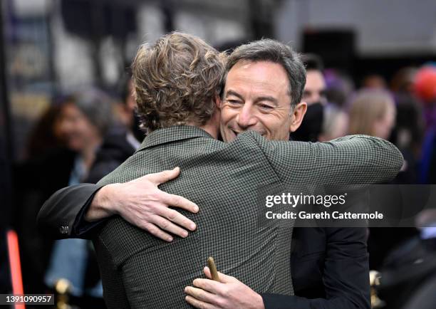 Johnny Flynn hugs Jason Isaacs at the "Operation Mincemeat" UK premiere at The Curzon Mayfair on April 12, 2022 in London, England.