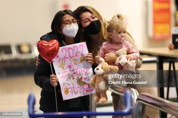 Tourists, friends and family are welcomed at Auckland International Airport on April 13, 2022 in Auckland, New Zealand. New Zealand borders reopened...