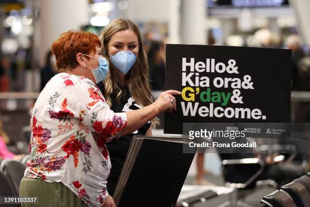 Tourists, friends and family are welcomed at Auckland International Airport on April 13, 2022 in Auckland, New Zealand. New Zealand borders reopened...