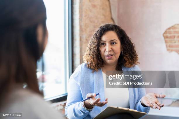 mid adult manager asks unrecognizable woman question in interview - bad employee stock pictures, royalty-free photos & images