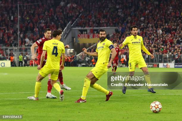 Robert Lewandowski of FC Bayern Muenchen scores their team's first goal past Pau Torres, Raul Albiol and Daniel Parejo of Villarreal CF during the...
