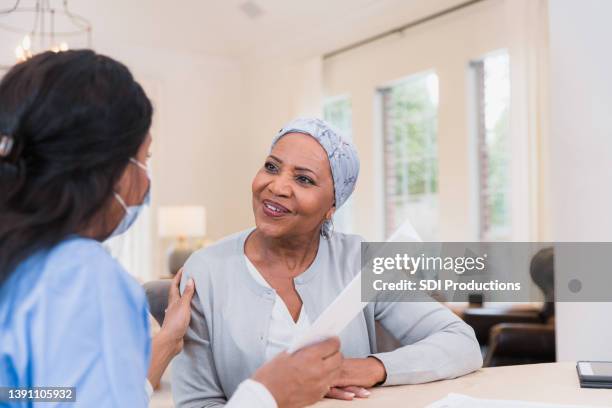 nurse comforts her patient - blank pamphlet stock pictures, royalty-free photos & images