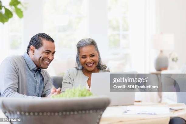 grandparents proudly watching their grandchild's school performance - financial advisor virtual stock pictures, royalty-free photos & images