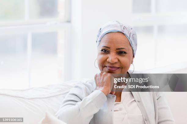beautiful woman contemplating life - headscarf home stockfoto's en -beelden