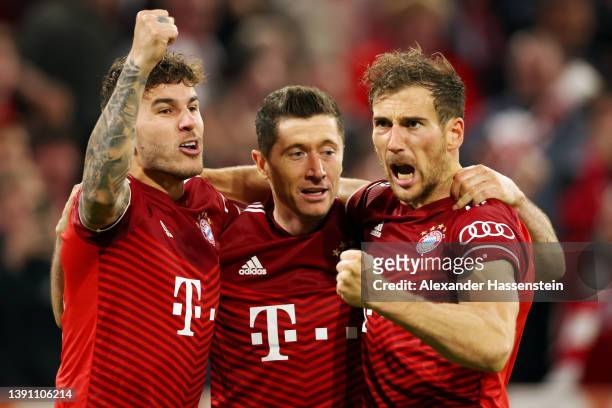 Robert Lewandowski of FC Bayern Muenchen celebrates with teammates Lucas Hernandez and Leon Goretzka after scoring their team's first goal during the...