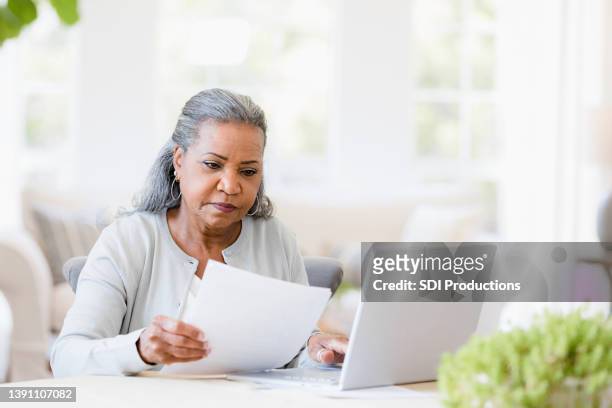 serious senior widow worried about home finances - weduwe stockfoto's en -beelden