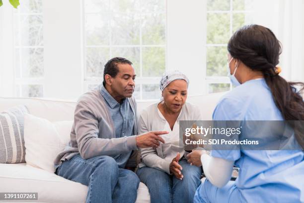 senior couple asks home healthcare nurse questions about chemo medication - chemotherapy man stock pictures, royalty-free photos & images