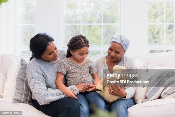 mid adult woman brings elementary age daughter to visit grandmother - children dreams 2011 open day of kids hospice stockfoto's en -beelden