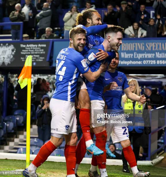 George Hirst of Portsmouth FC is congratulated by team-mates after he scores a goal to make it 3-0 during the Sky Bet League One match between...