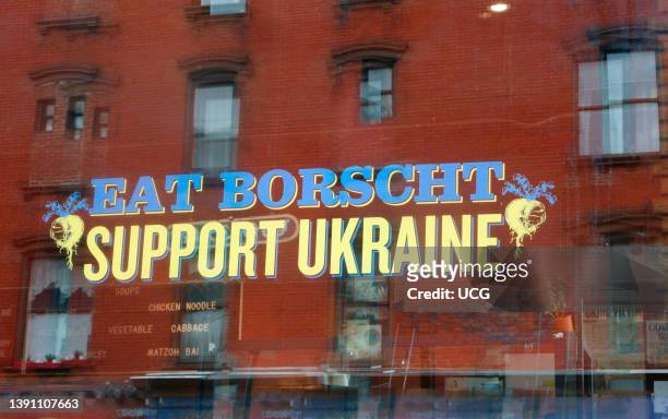 Message on window, Eat Borscht Support Ukraine, Veselka Ukrainian Restaurant, Second Avenue, New York City.