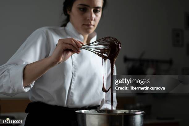 female confectioner preparing chocolate sauce - chef patissier stock pictures, royalty-free photos & images