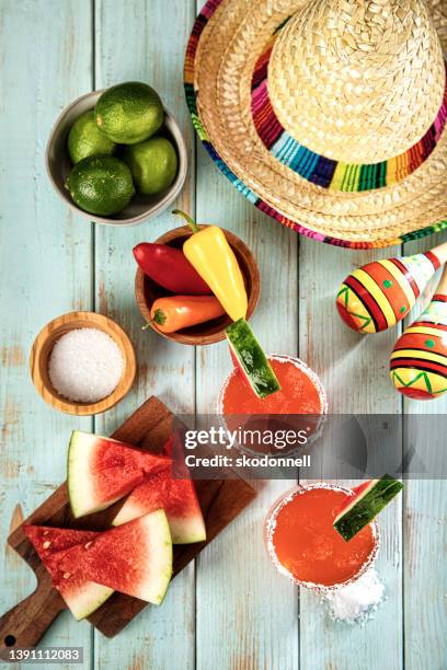 margarita glass and watermelon on a light blue cool wood background - margarita stock pictures, royalty-free photos & images