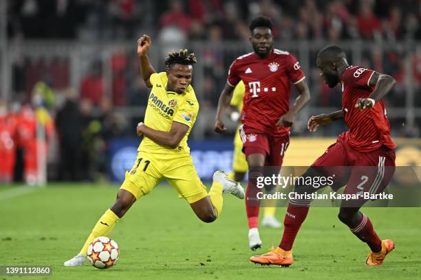 Samu Chukwueze of Villareal challenges Dayot Upamecano of FC Bayern Muenchen during the UEFA Champions League Quarter Final Leg Two match between...