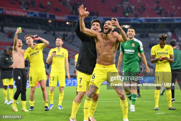 Gerard Moreno and Etienne Capoue of Villarreal CF celebrate with teammates following their draw and advancement in the UEFA Champions League Quarter...